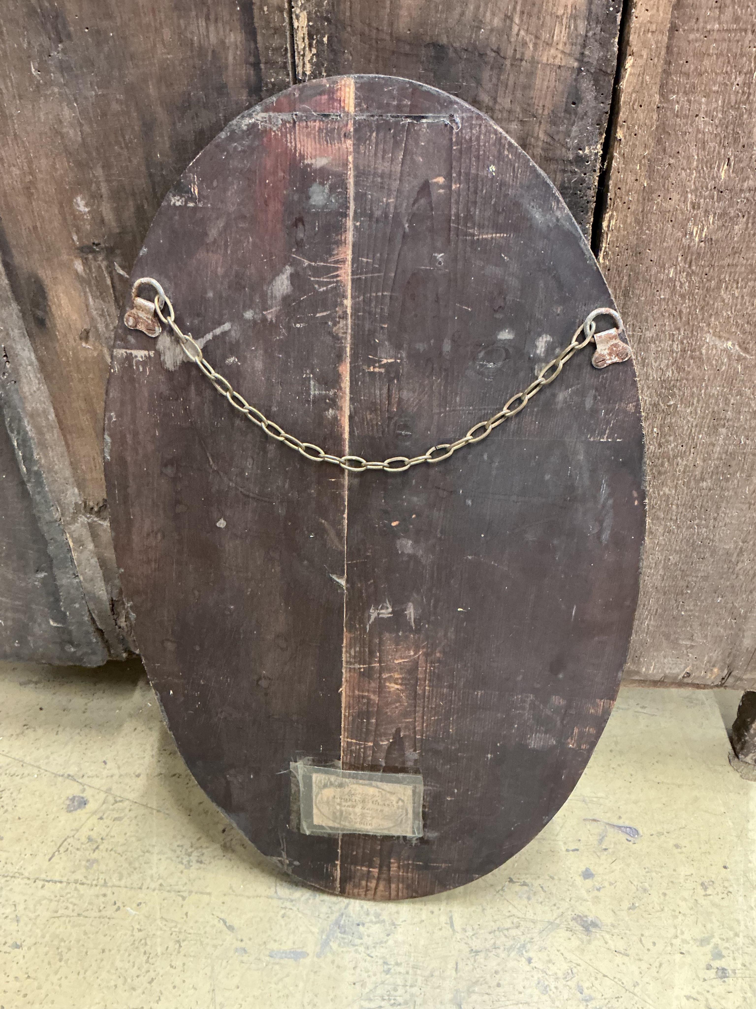 An oval Irish style wall mirror, width 37cm, height 65cm